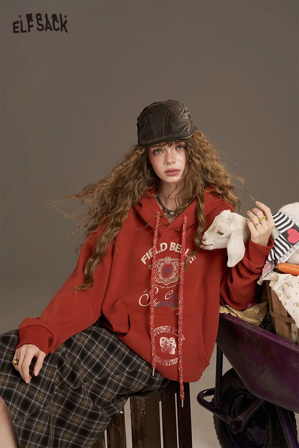 ELFSACK women's oversized print hoodie in red paired with a plaid skirt and casual accessories