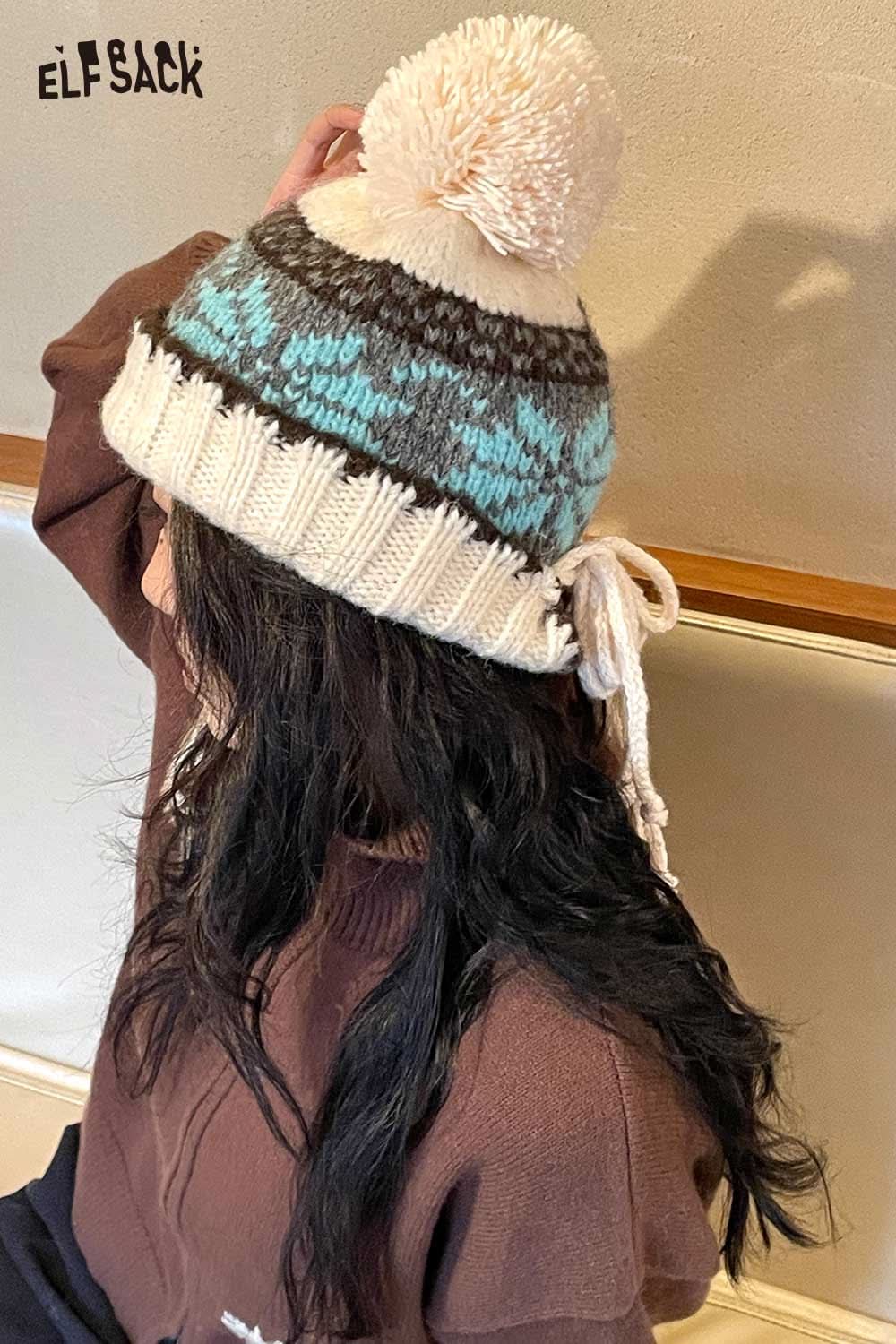 ELFSACK women's patchwork knit hat in cream with blue and brown patterns and a fluffy pom pom