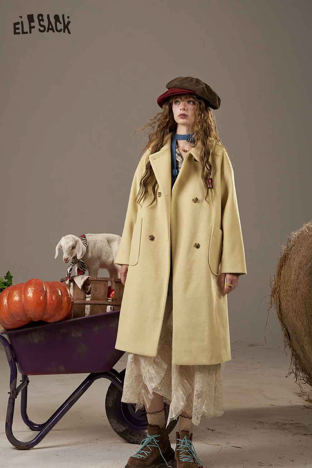 ELFSACK women's patterned collared coat in yellow, styled with a vintage hat and a rustic backdrop