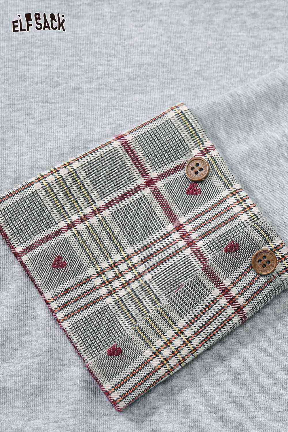 Close-up of ELFSACK women's plaid detail tee featuring a cozy plaid patch and button accents