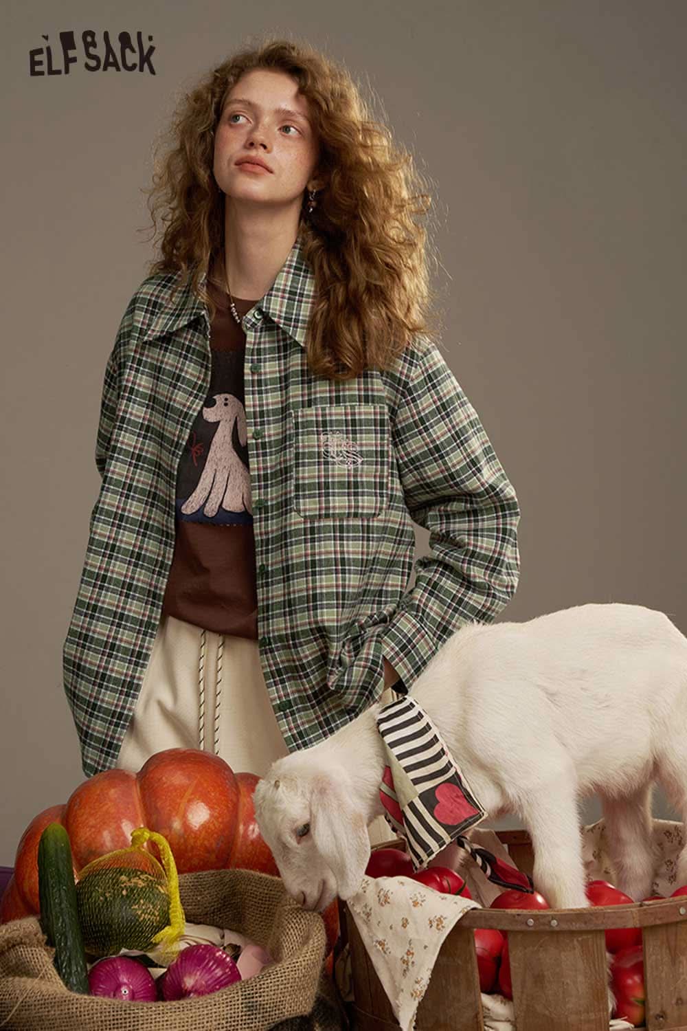 ELFSACK women's plaid shirt with back print styled over a graphic tee, surrounded by fresh produce