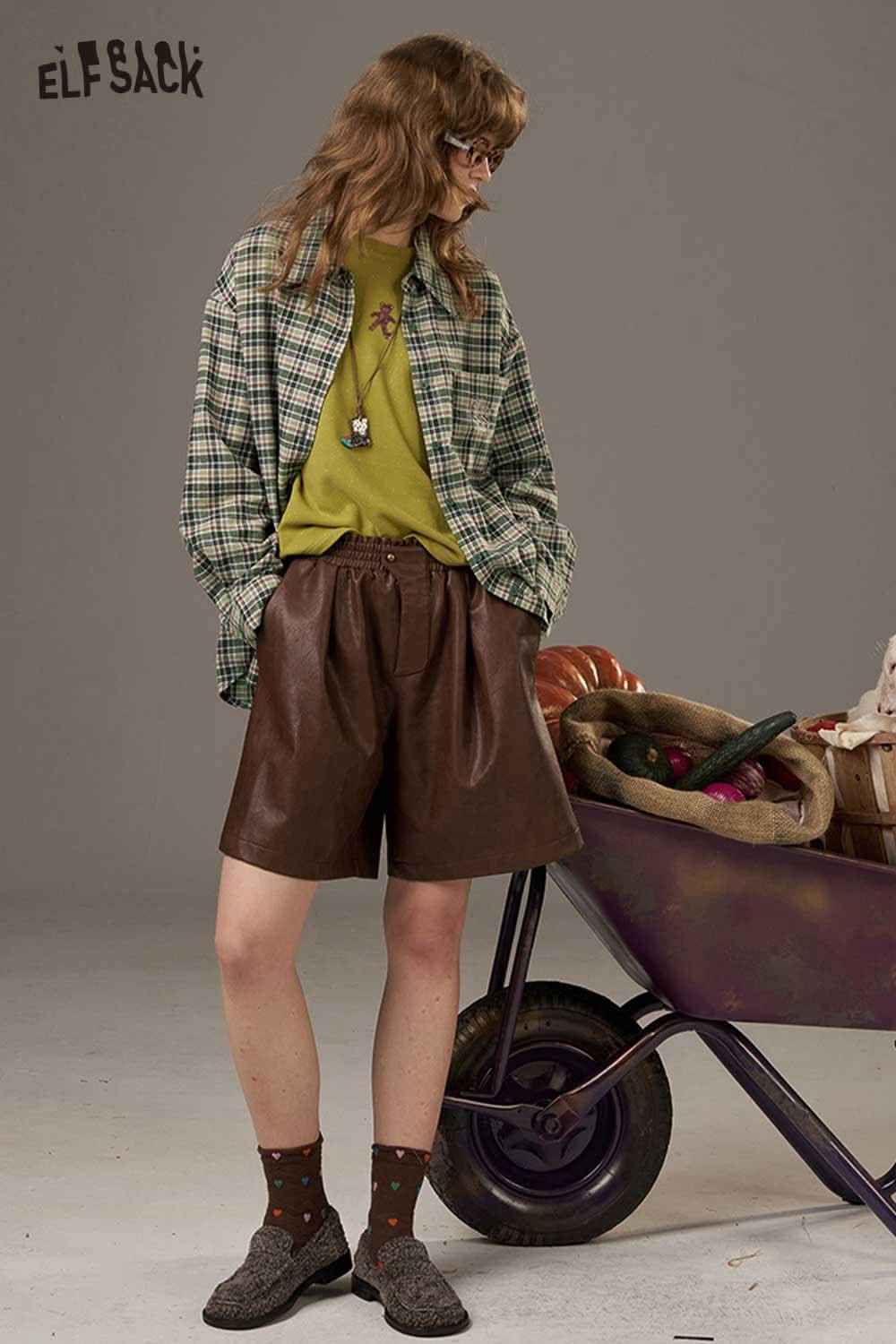 ELFSACK women's plaid shirt with back print styled with green top and brown shorts for a trendy look