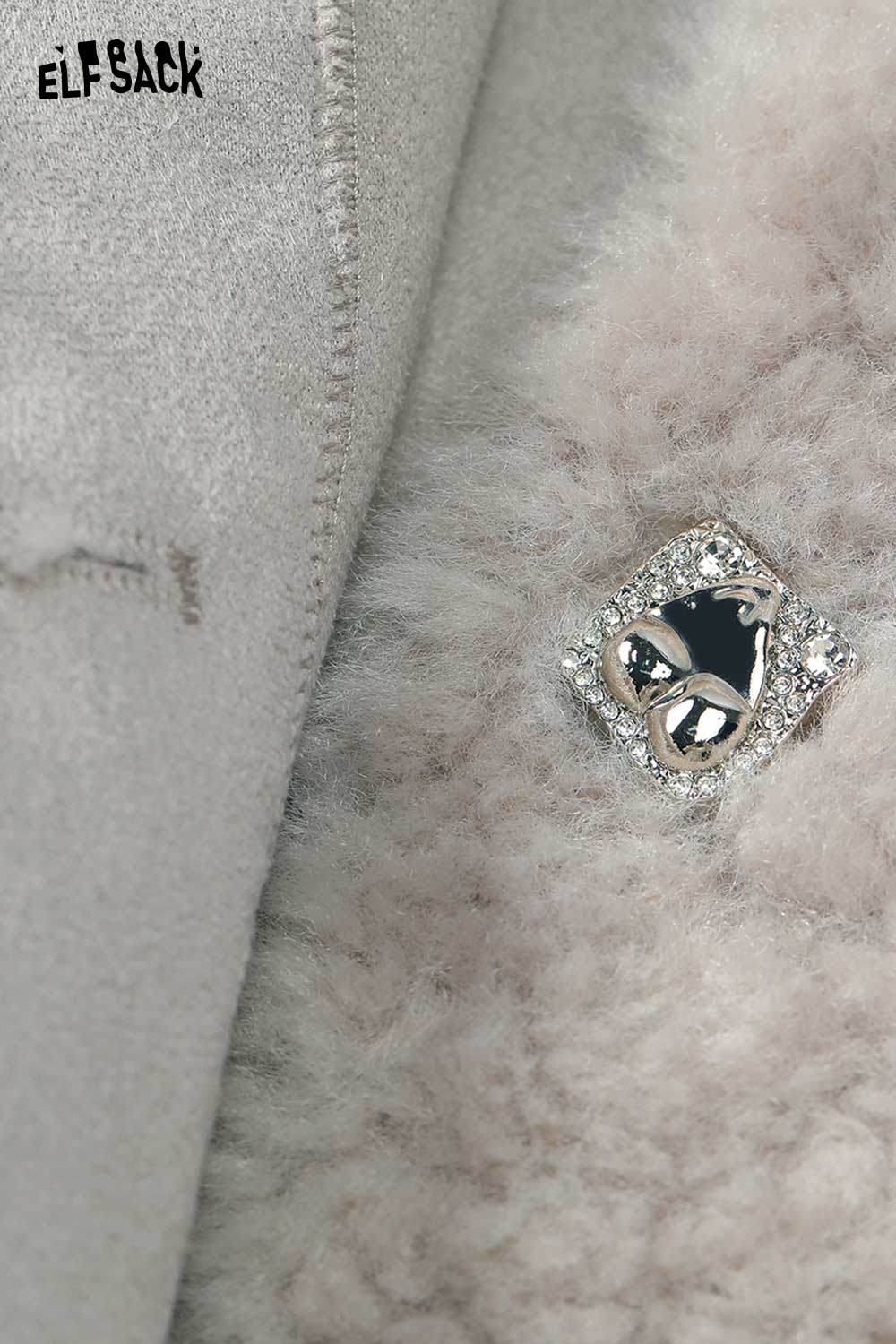 Close-up of ELFSACK women's plush short coat featuring a decorative pin detail on soft fabric