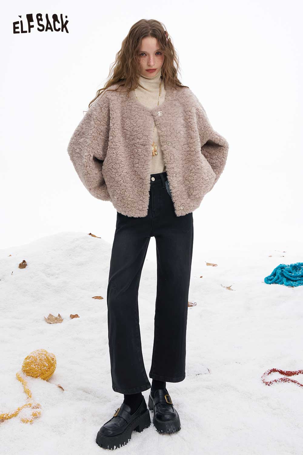 Model wearing ELFSACK women's plush tapered jeans styled with a cozy jacket in a winter setting