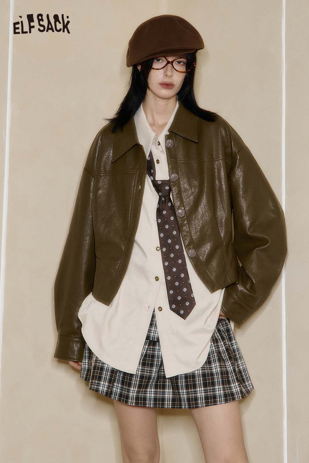ELFSACK women's PU cropped moto jacket in brown worn over a shirt and plaid skirt