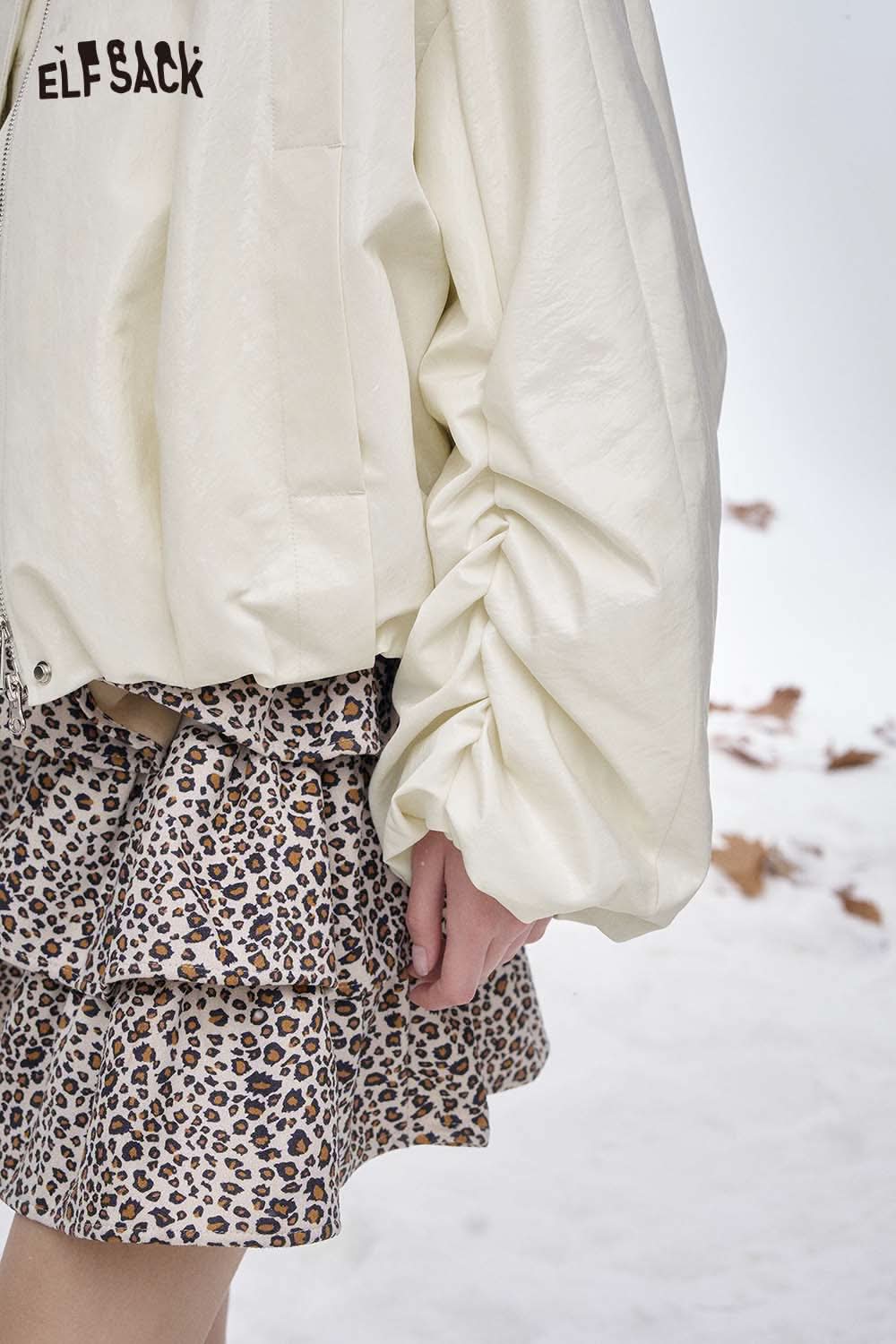 ELFSACK women's puff sleeve down jacket in white, styled with a leopard print skirt in a winter setting