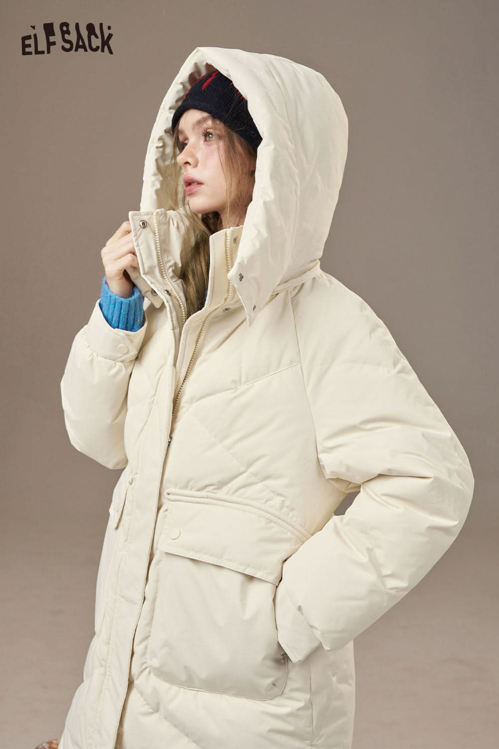 ELFSACK women's quilted puffer jacket in cream with a cozy hood and pockets for warmth