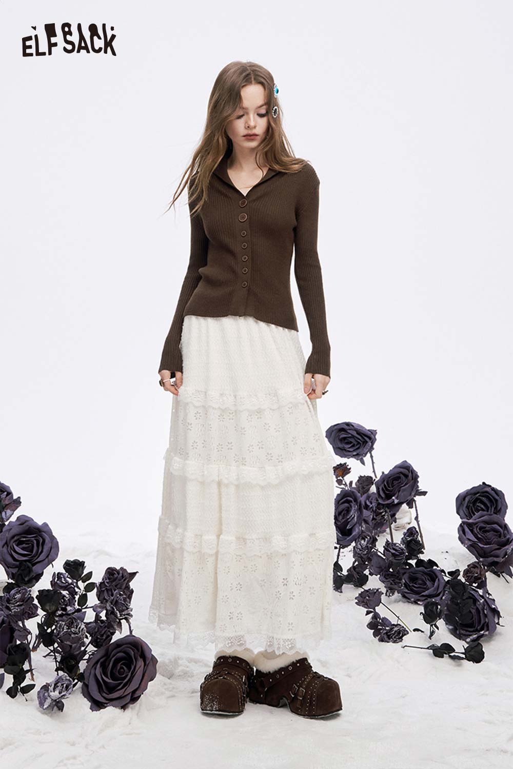 ELFSACK women's slim fit v neck knitwear paired with a lace skirt, surrounded by purple roses