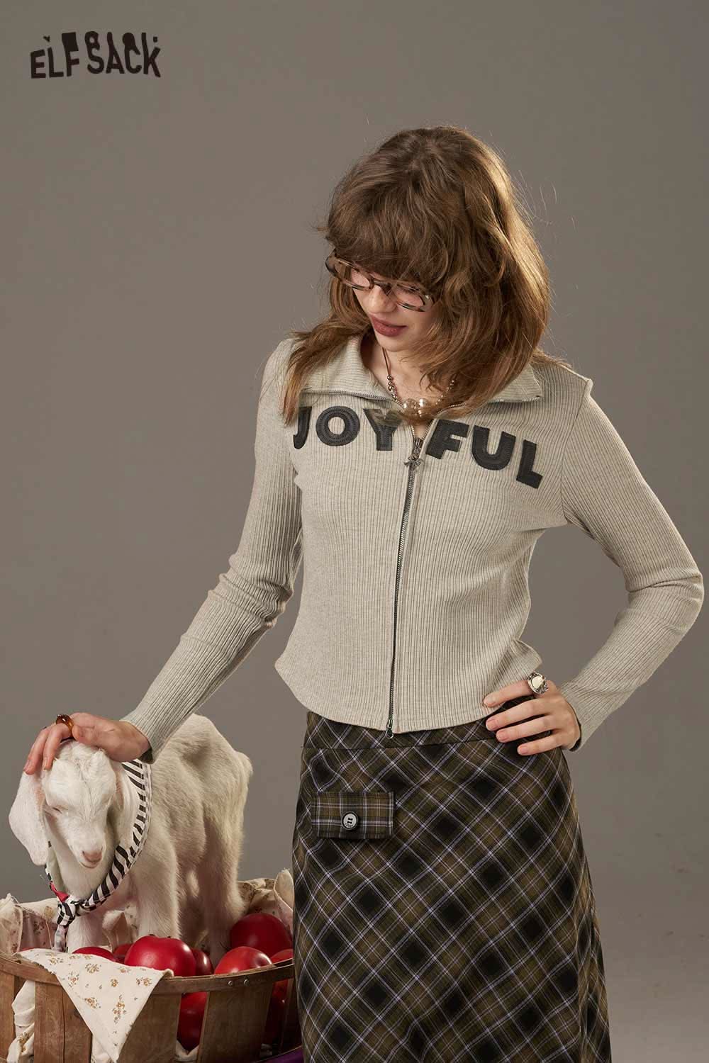 ELFSACK women's slimming zip up shirt in light gray with JOYFUL text, styled with a plaid skirt
