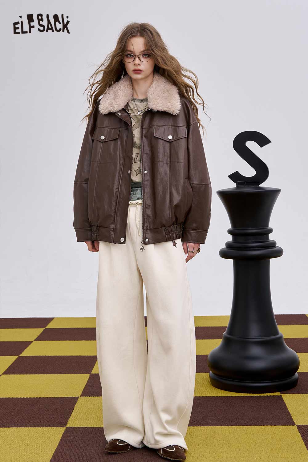 ELFSACK women's soft graphic long sleeve t-shirt paired with a stylish brown leather jacket and wide-leg pants