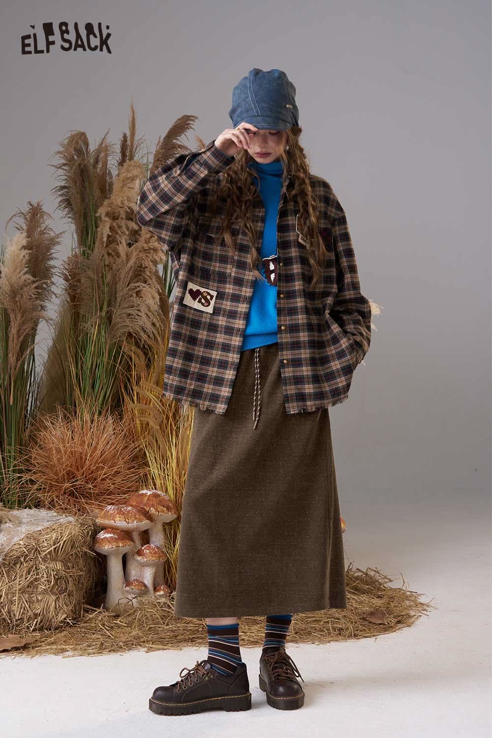ELFSACK women's soft textured midi skirt paired with a plaid jacket and blue sweater in a stylish setting