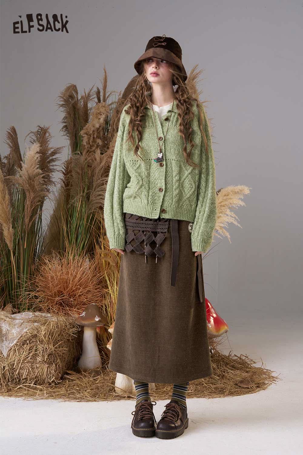 ELFSACK women's soft textured midi skirt styled with a cozy green cardigan in a nature setting
