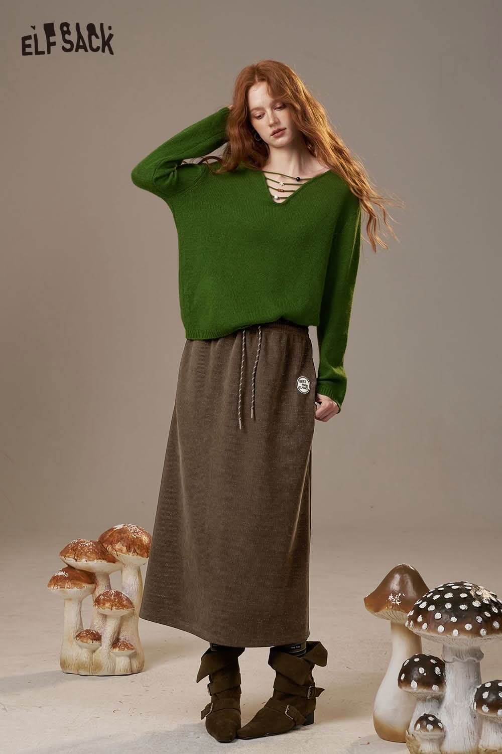 ELFSACK women's soft textured midi skirt styled with a green sweater for a casual look