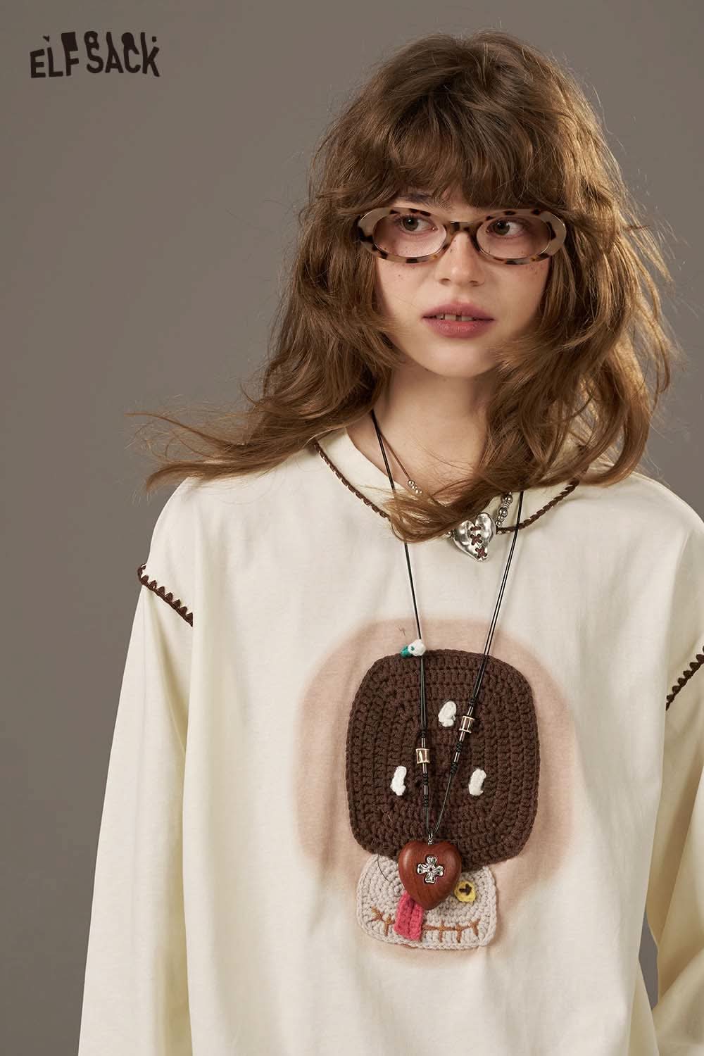 ELFSACK women's soft yarn sweatshirt featuring a unique crochet design and stylish accessories