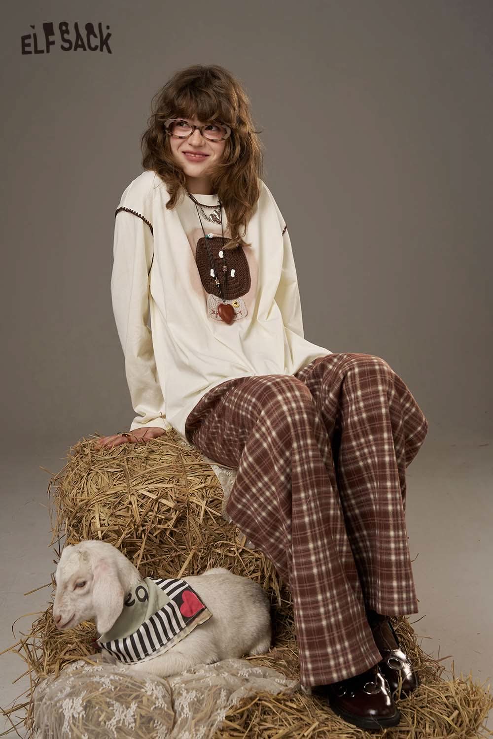 ELFSACK women's soft yarn sweatshirt in cream, styled with relaxed plaid pants for a cozy look