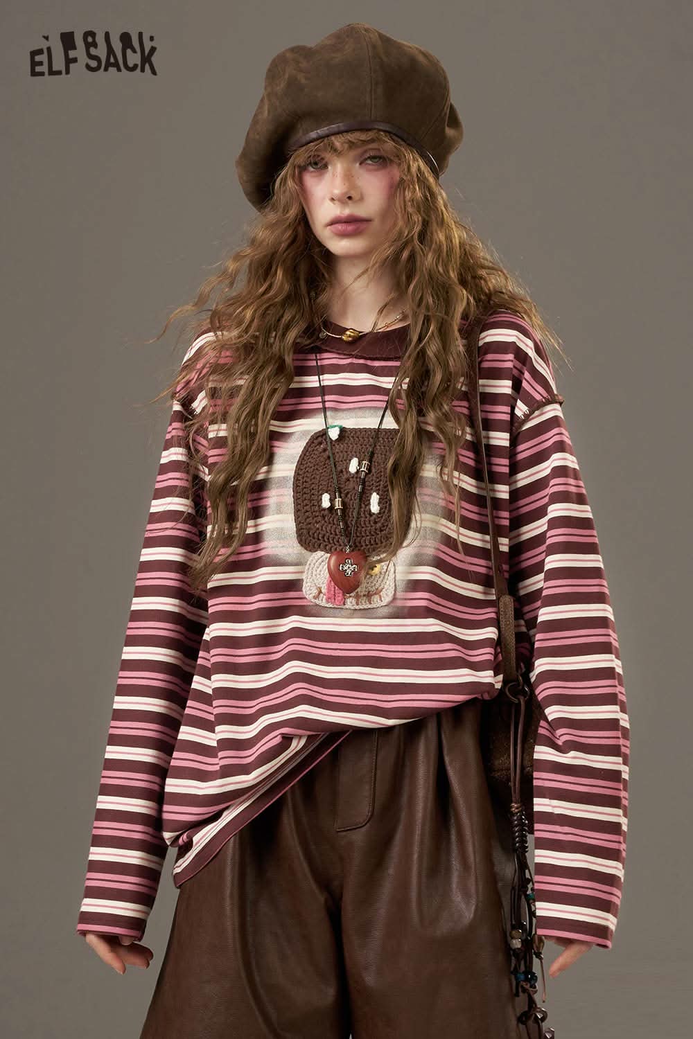 ELFSACK women's soft yarn sweatshirt featuring a striped design and playful graphic on the front