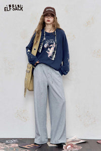 Stylish model wearing casual outfit featuring a women's star print cotton tee paired with gray pants