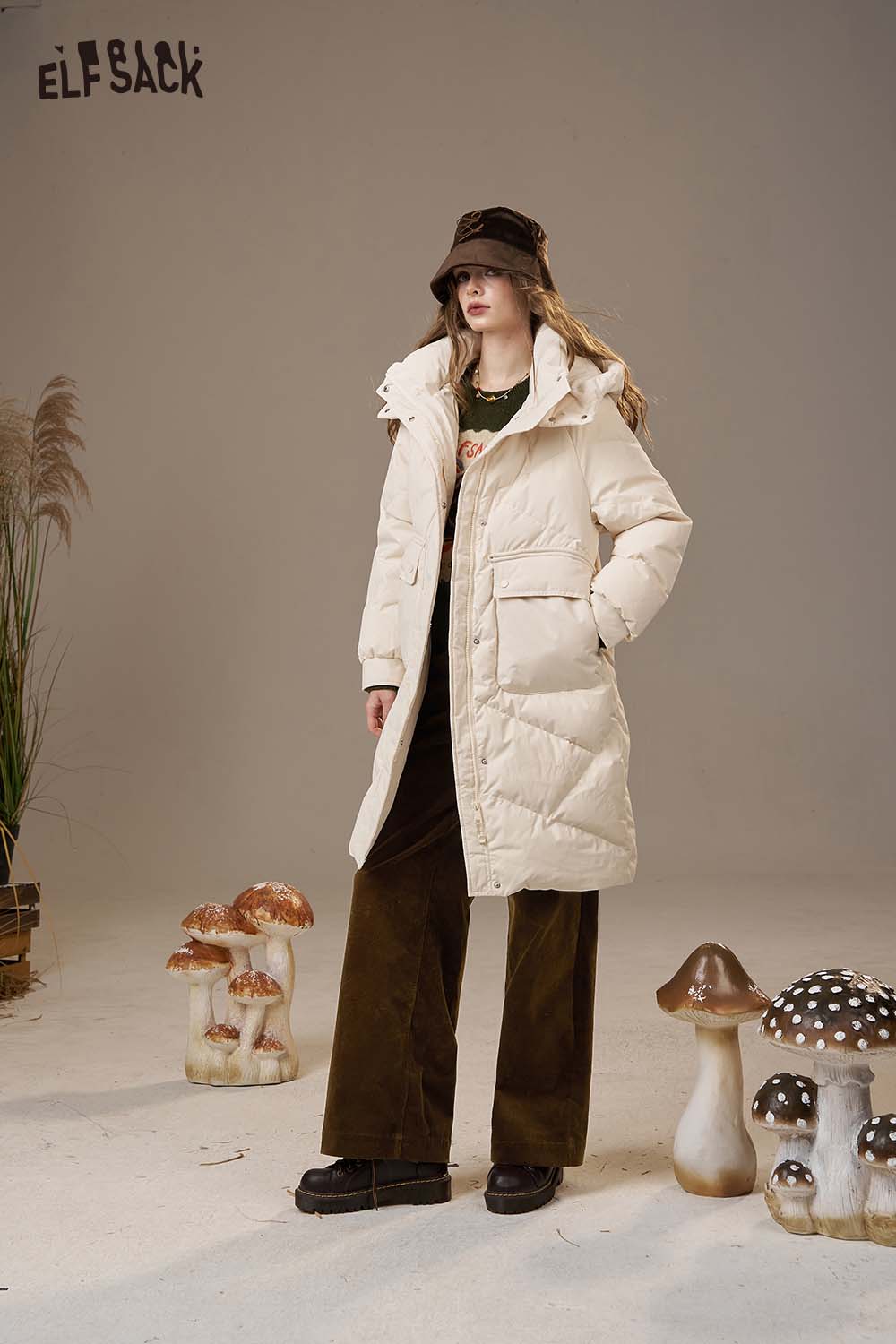 ELFSACK women's straight leg cotton blend pants styled with a cream winter coat and layered over a green top.
