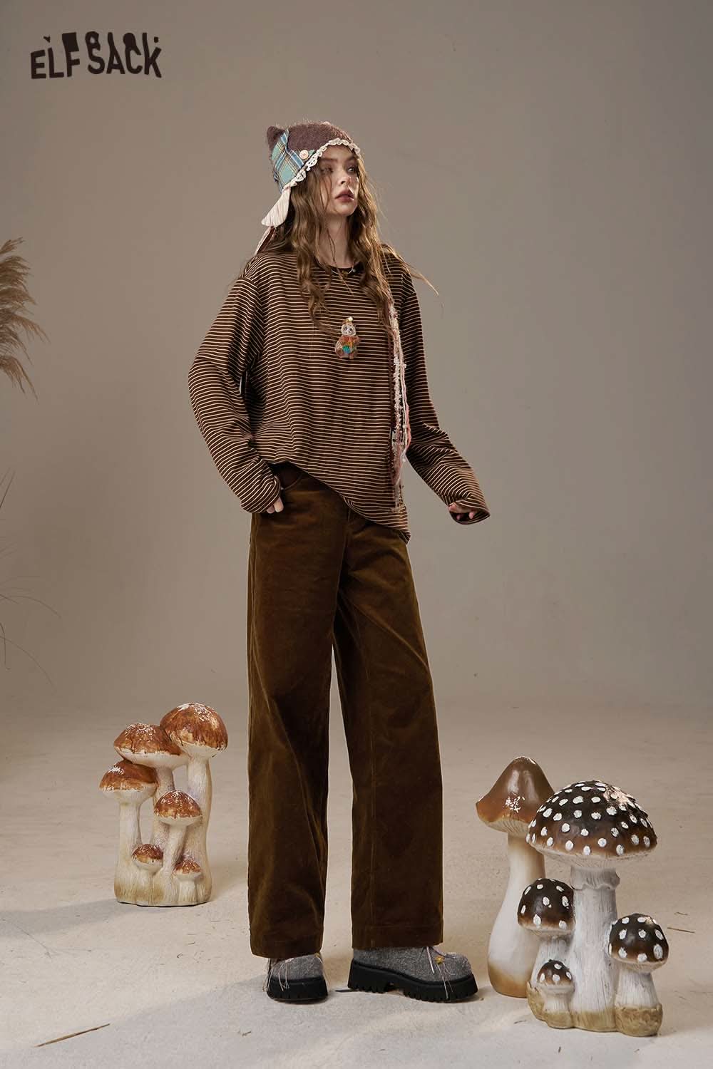 Fashionable model wearing women's straight leg cotton blend pants with a cozy striped top