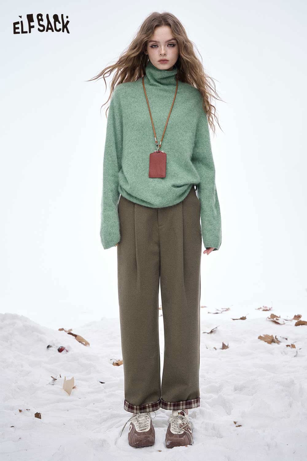 Model wearing ELFSACK women's striped cuff straight pants paired with a cozy green sweater