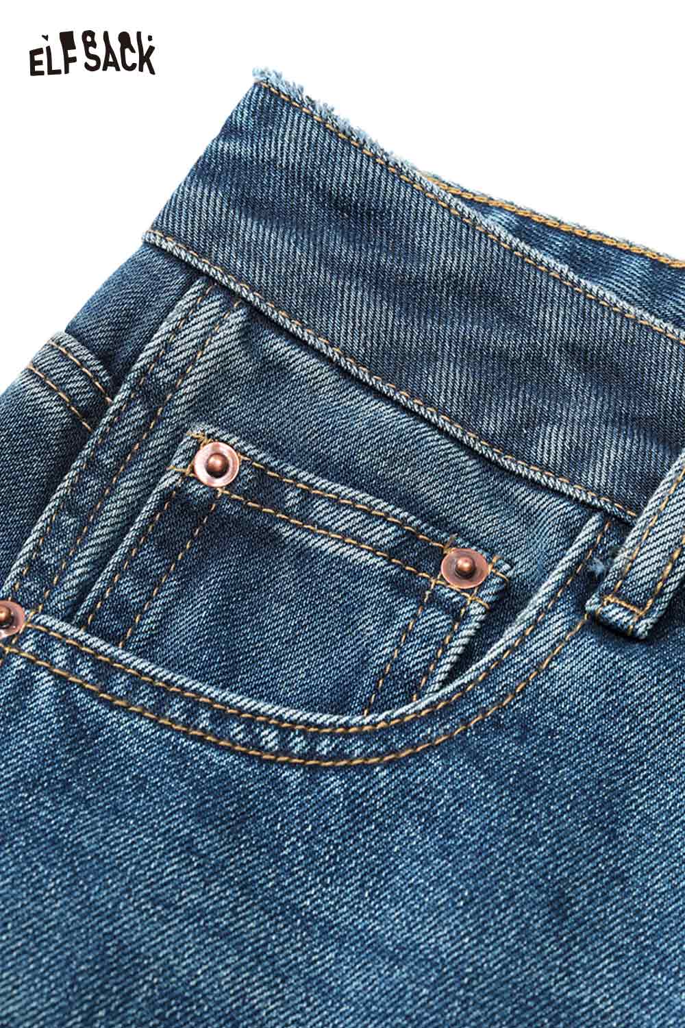 Close-up of ELFSACK women's vintage washed jeans with detailed stitching and copper rivets