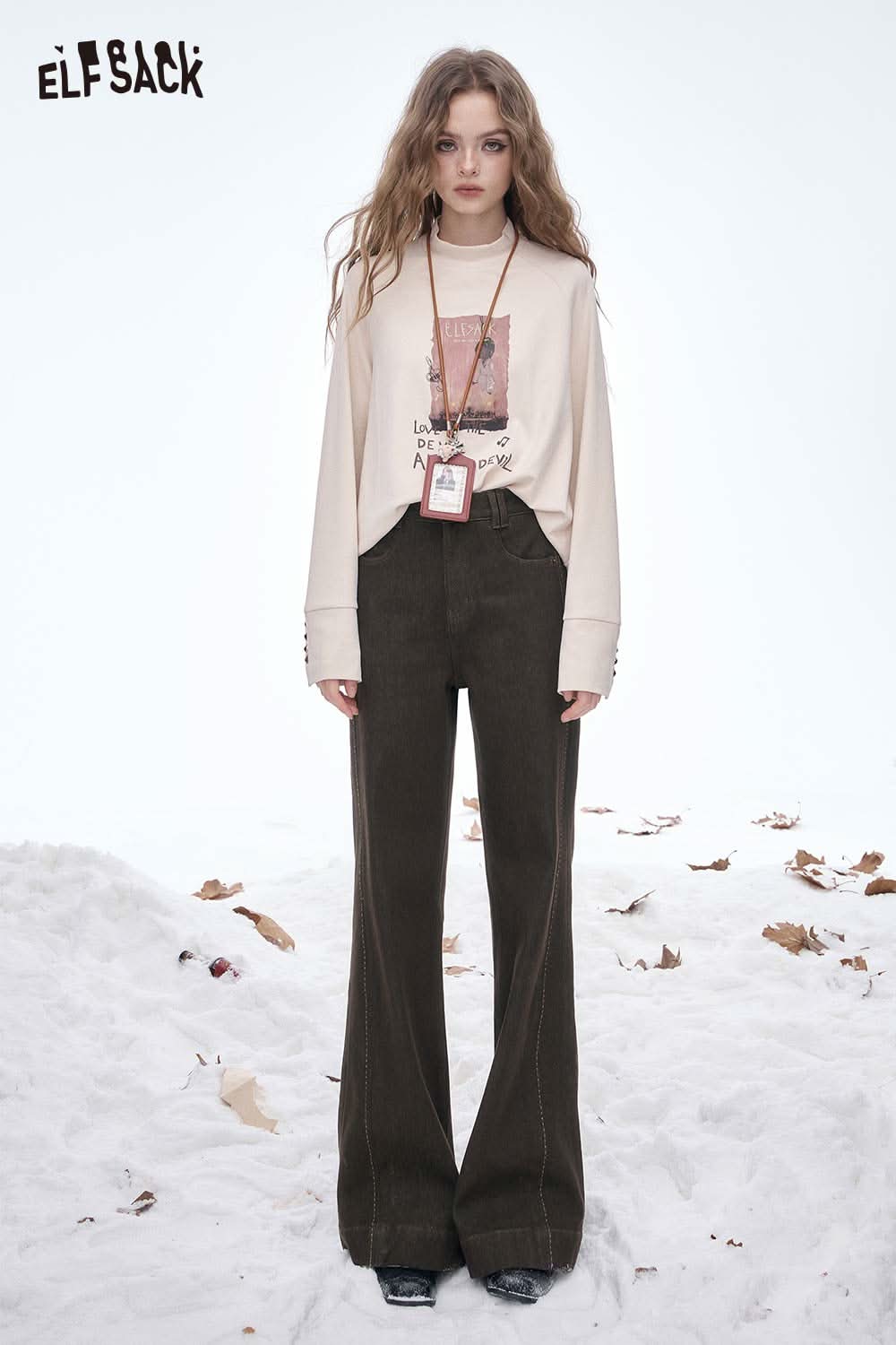 ELFSACK women's wide leg floor length jeans styled with a graphic long-sleeve shirt in a snowy setting