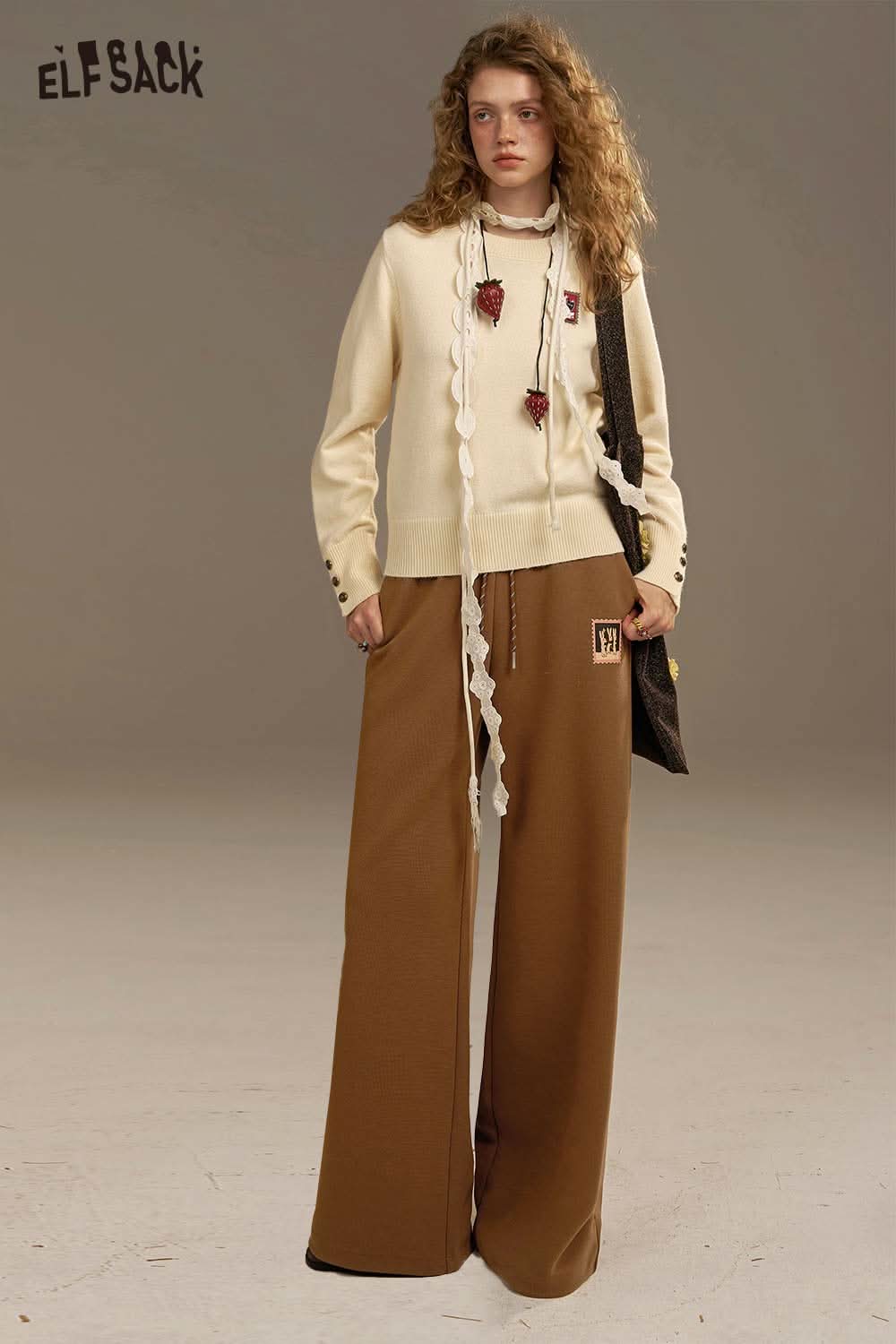 Stylish women's wide leg sweatpants from ELFSACK in brown, paired with a matching top for a trendy look
