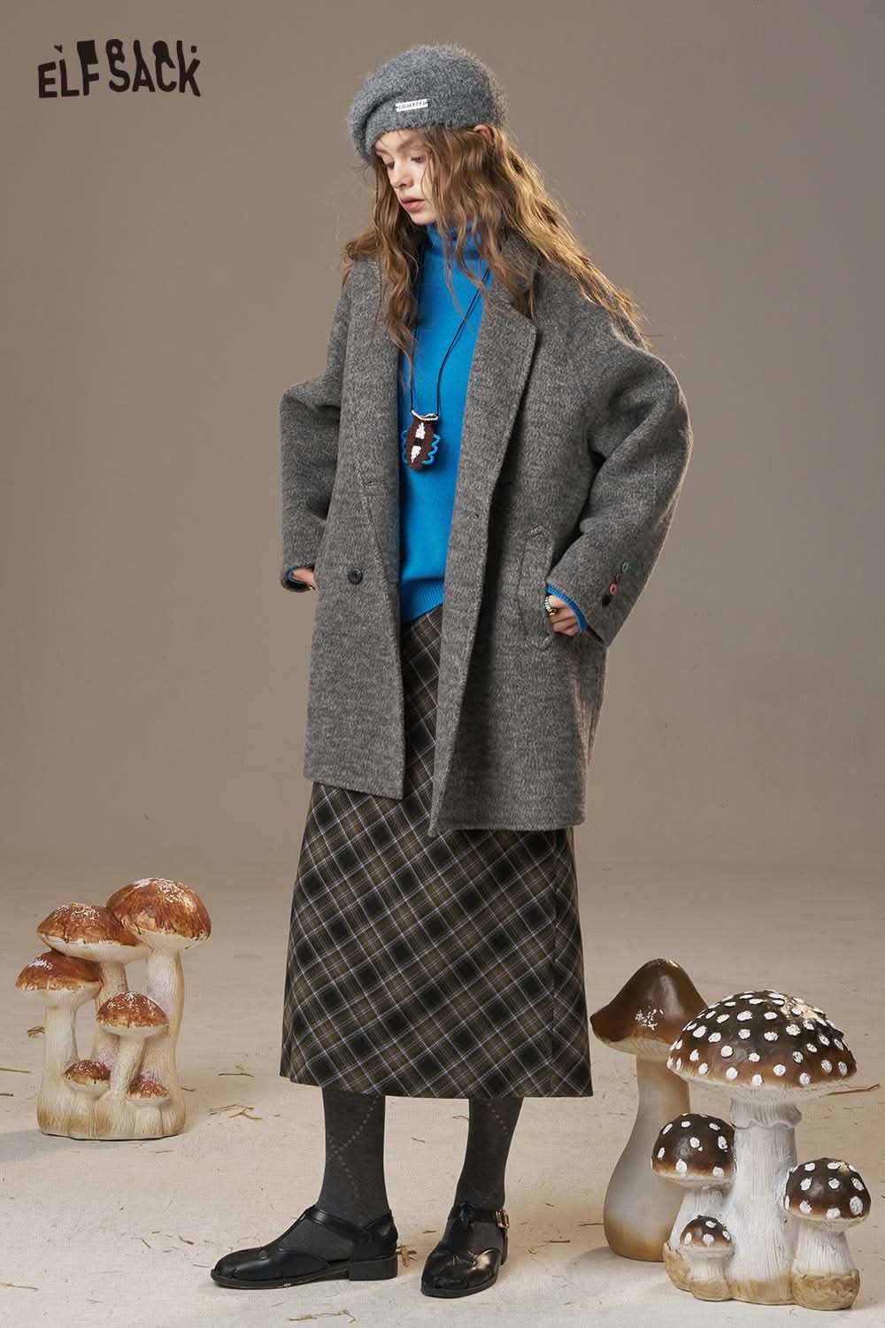 ELFSACK women's wool turtleneck sweater in blue paired with a gray coat and plaid skirt