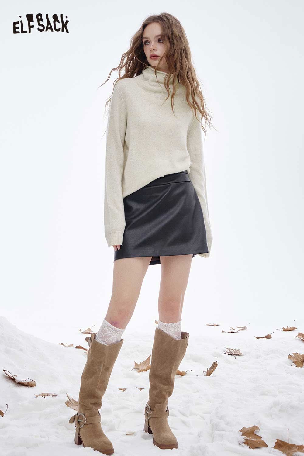 ELFSACK women's wool turtleneck sweater in cream paired with a black leather skirt and knee-high boots