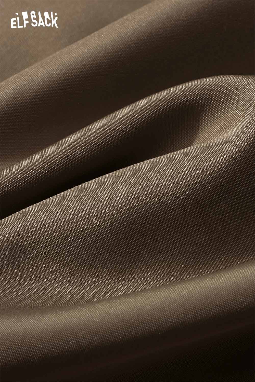 Close-up of soft fabric texture for ELFSACK wool blend plaid midi skirt in rich brown tone