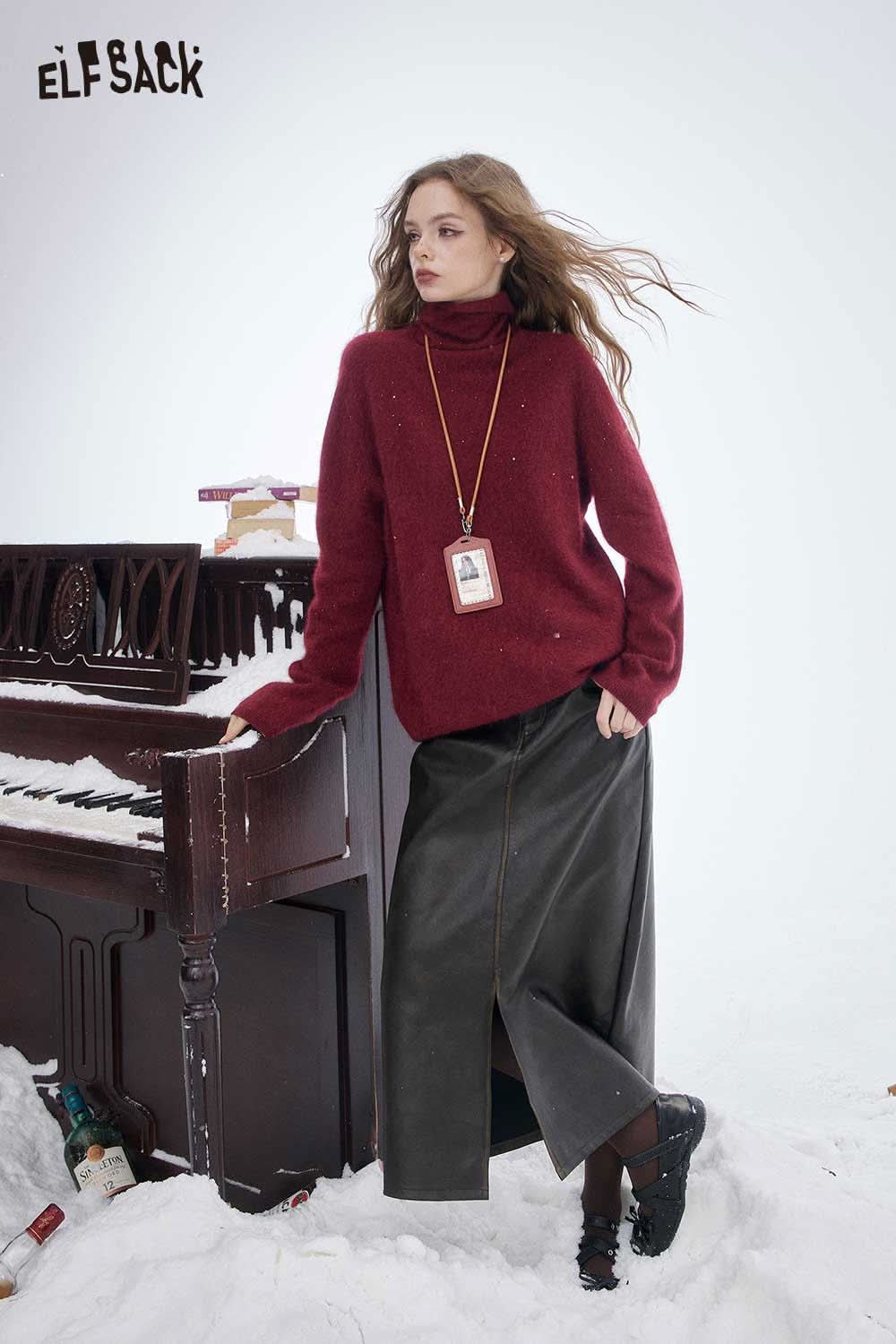 ELFSACK wool high neck sweater women in burgundy style paired with a long skirt in winter setting