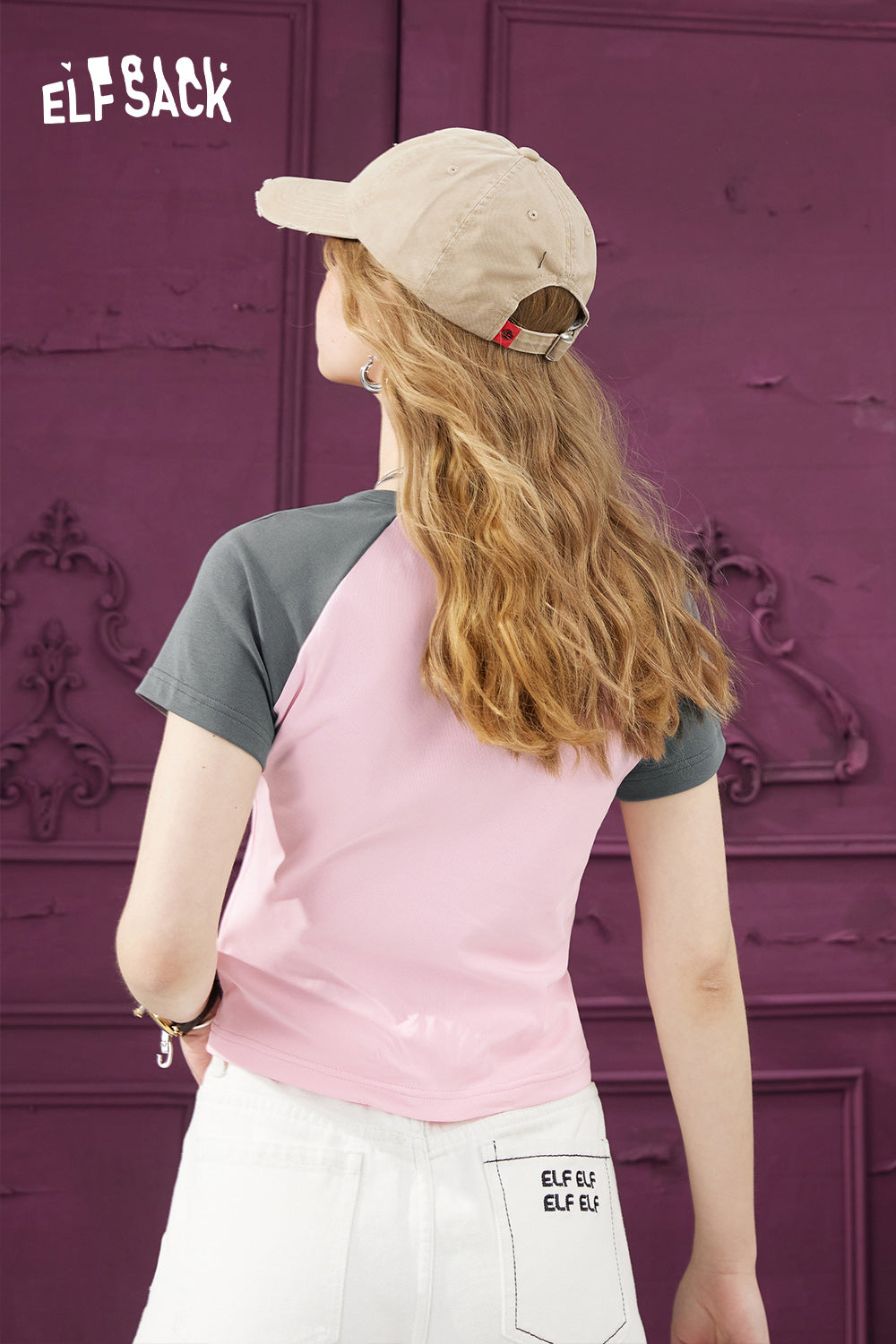 ELFSACK Y2K Heart Graphic pink and gray raglan sleeve T-shirt worn by model with beige cap