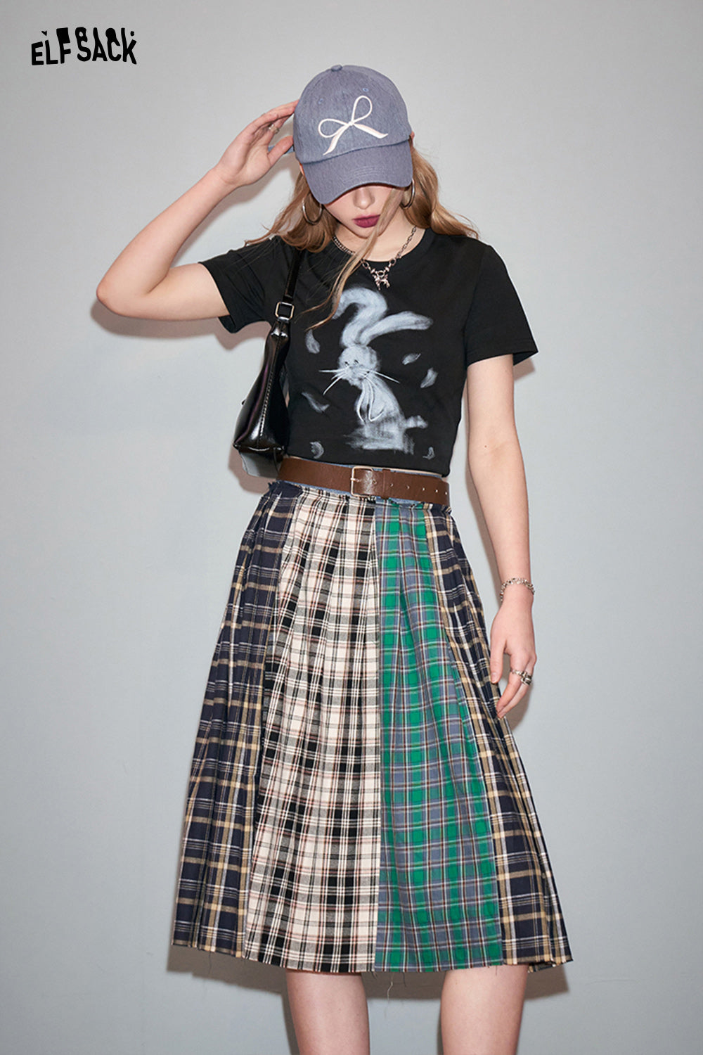 ELFSACK black T-shirt with Y2K Rabbit Print paired with a multicolor plaid skirt and gray cap