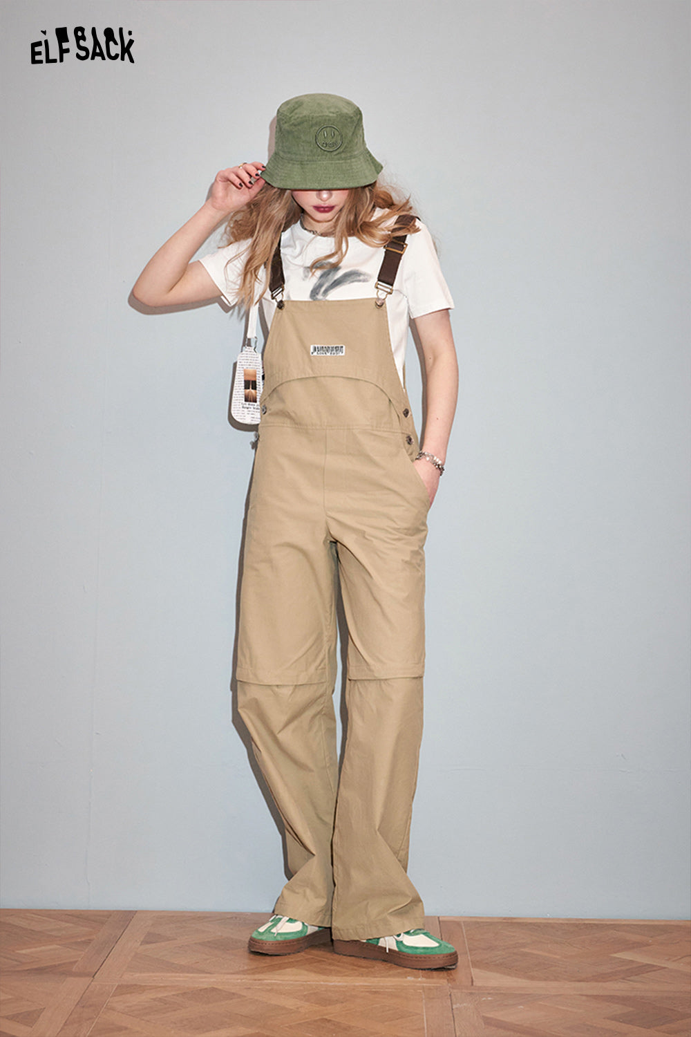 ELFSACK casual outfit featuring Y2K Rabbit Print t-shirt paired with beige overalls and green bucket hat