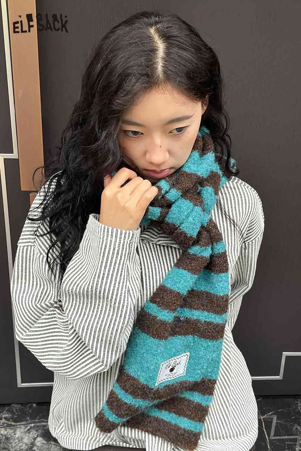 Y2K stripe neck warmer by ELFSACK in teal and brown, styled with a striped shirt for a trendy look