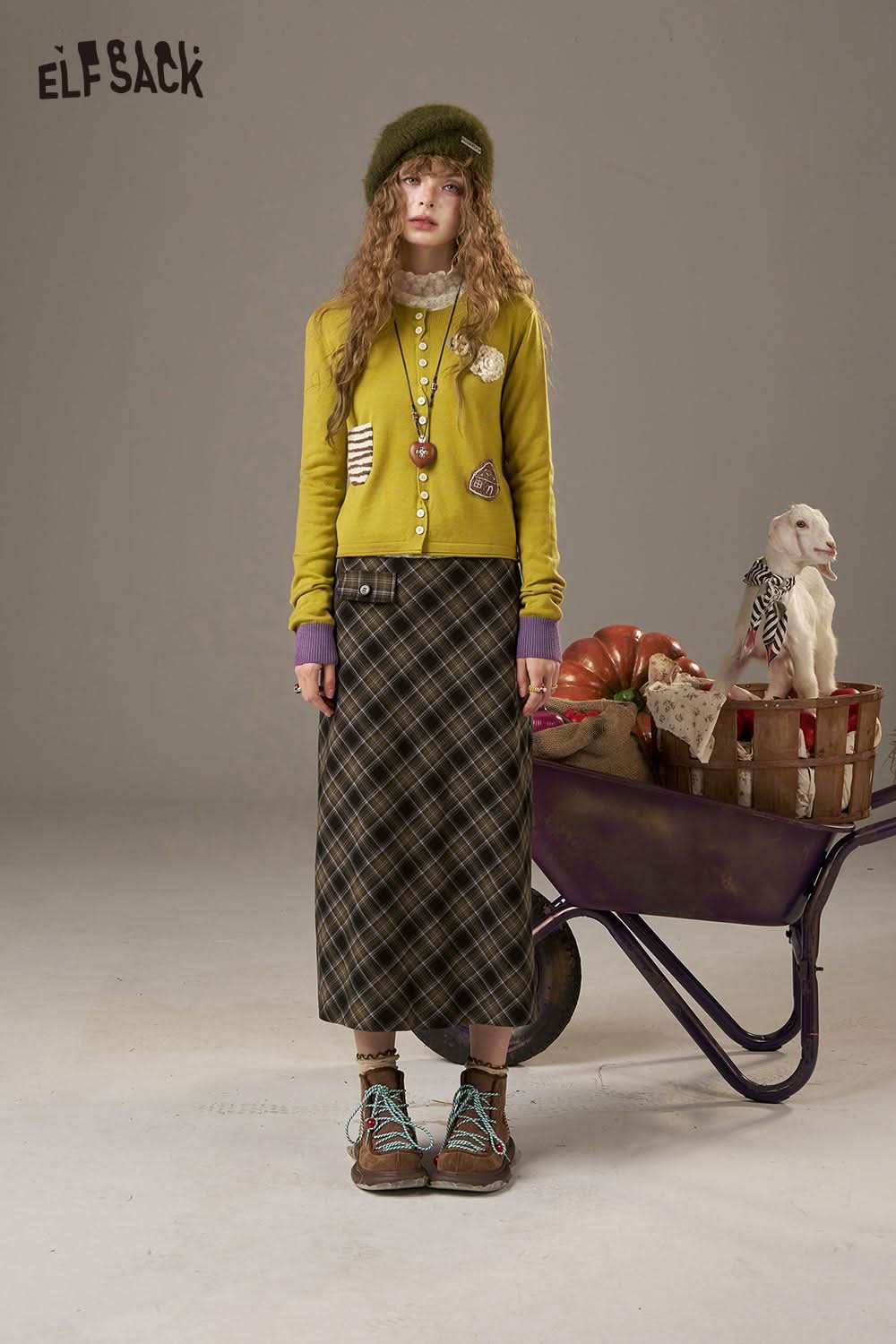 ELFSACK zebra print knit sweater for women styled with a plaid skirt and accessories