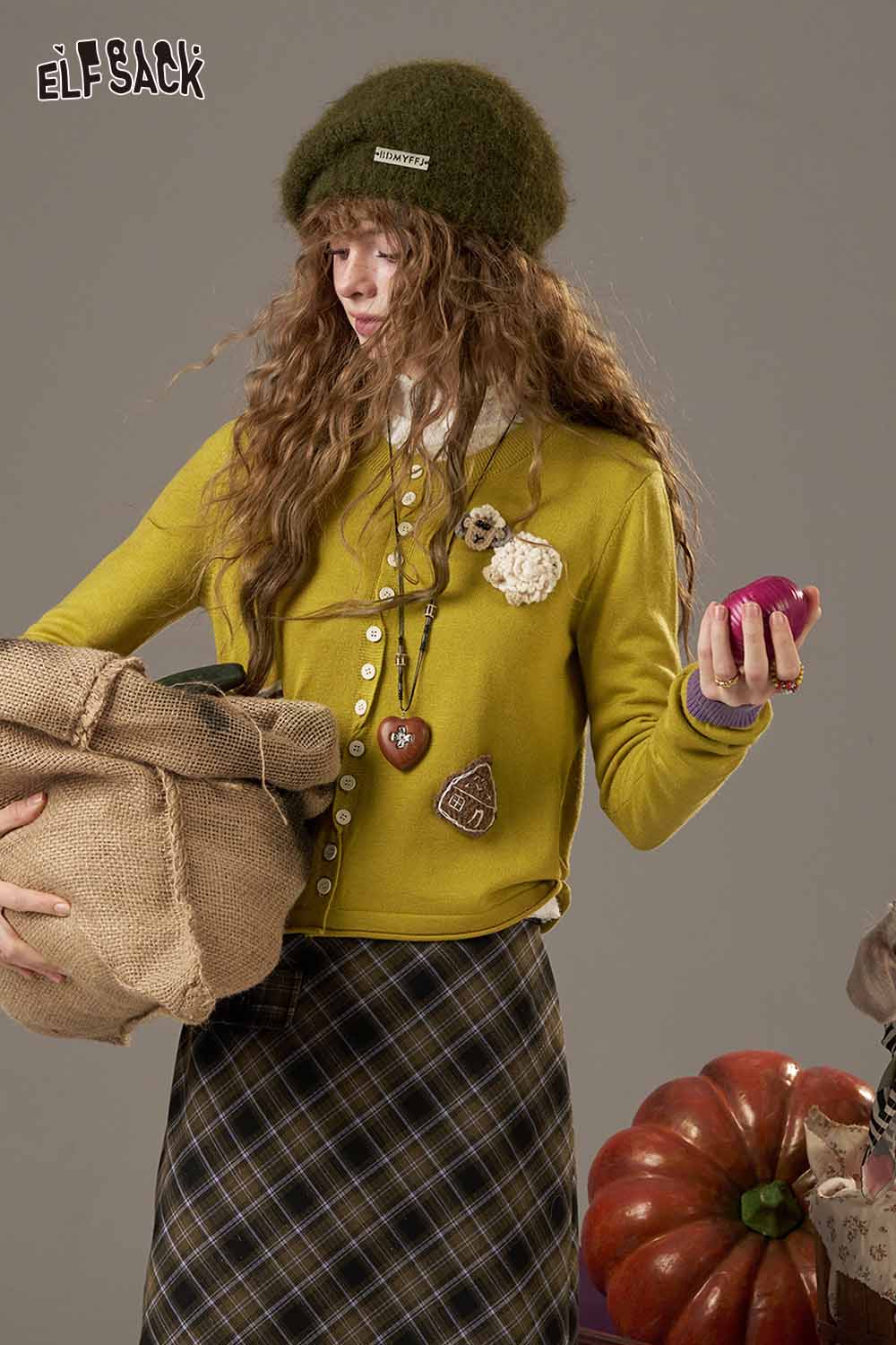 ELFSACK zebra print knit sweater for women styled with a plaid skirt and accessories