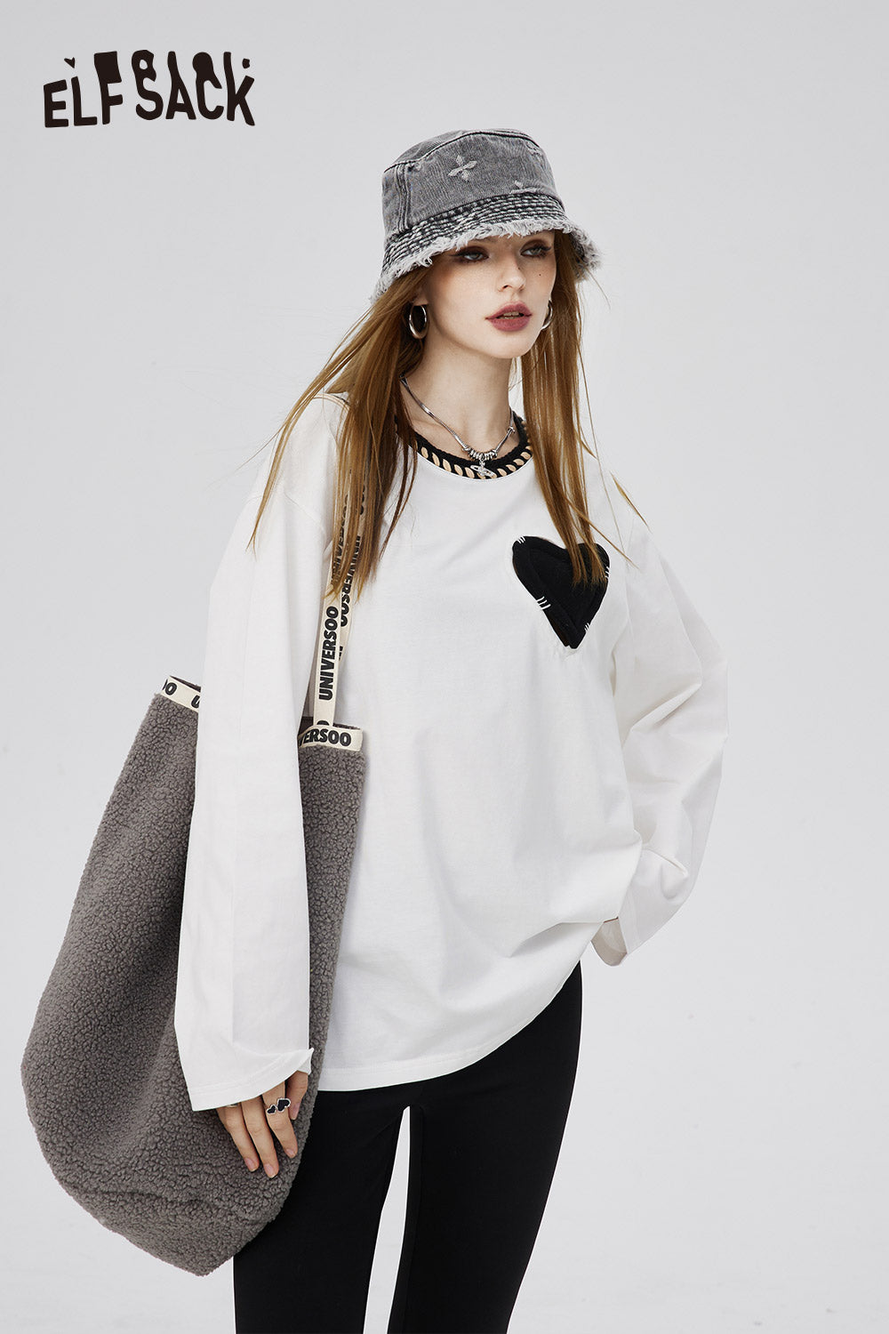 ELFSACK white Cotton Heart Embroidered T-shirt with black heart detail worn with gray bucket hat and tote bag